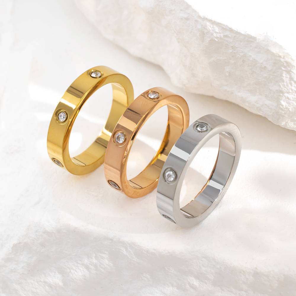 Stainless steel plated with 18K gold and set with diamonds - classic three-diamond couple rings